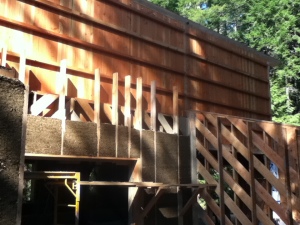 Chip and slip timber frame with a stave wall above.  Wood work by Pat Woodland of Woodland Boat Works, Cobble Hill, BC